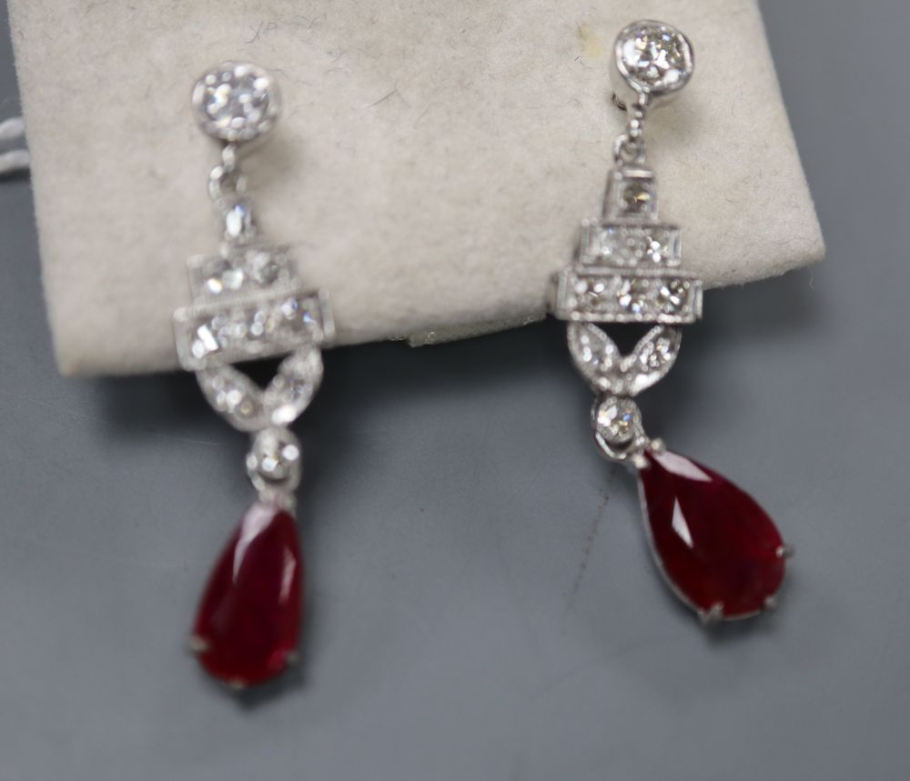 A pair of modern Art Deco style white metal (stamped 14k), ruby and diamond set drop screw back earrings, 32mm, gross 4.9 grams.